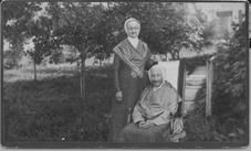 SA0055 - An unidentified woman and Dolly Saxton are seated outside.
